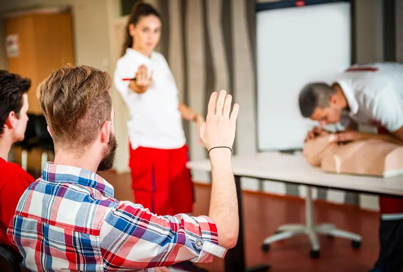 CPR training session with instructor and participants.
