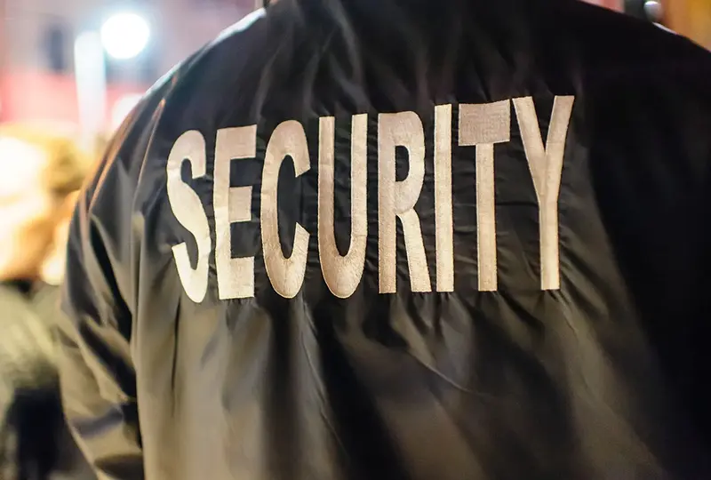 Security guard jacket with bold lettering.
